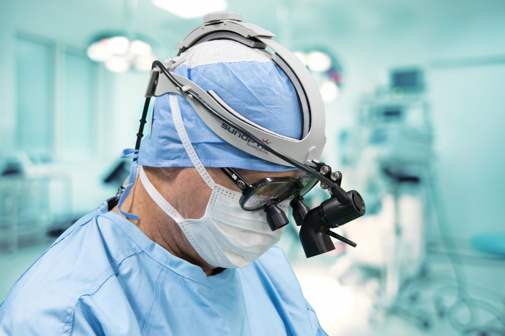Surgeon wearing LED 9500 Battery Operated Headlight with Gray Headband