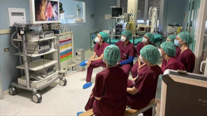 A medical team watching a recorded procedure